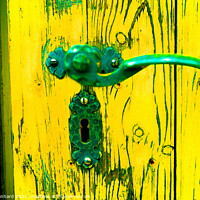 Buy canvas prints of A closeup shot of an old metal handle and lock on the weathered yellow wooden door by Ingo Menhard