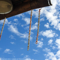Buy canvas prints of A low angle shot of hanging chains against cloudy sky by Ingo Menhard