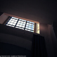 Buy canvas prints of A low-angle shot of a small square window with bars in the dark room by Ingo Menhard