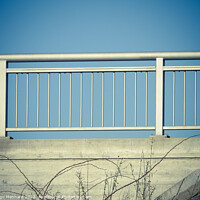 Buy canvas prints of Closeup shot of iron porch railings on a blue sky background by Ingo Menhard