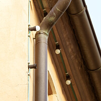 Buy canvas prints of A vertical shot of a copper gutter and light bulbs on a bu by Ingo Menhard