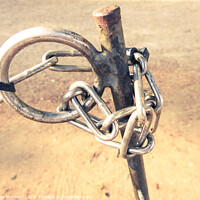 Buy canvas prints of A selective focus shot of a chain on a pole by Ingo Menhard