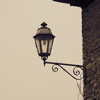 Buy canvas prints of Closeup of a vintage wall-mounted lantern in the light background by Ingo Menhard