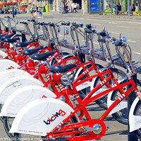 Buy canvas prints of Hire bicycles at Barcelona in Spain. by john hill