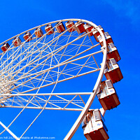 Buy canvas prints of Ferris wheel against a blue sky. by john hill