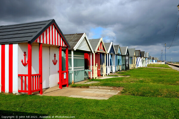 Stormy Skies over beach huts. Picture Board by john hill