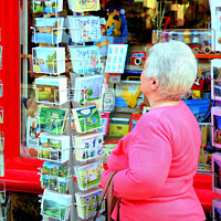 Buy canvas prints of Browsing post cards. by john hill