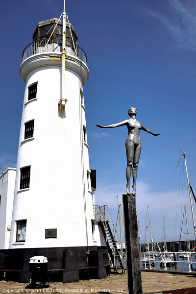 Bathing Belle and Harbour lighthouse, Scarborough, Yorkshire. Picture Board by john hill