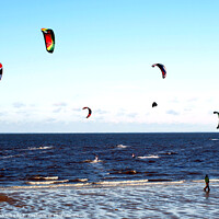 Buy canvas prints of Harnessing Coastal Breezes: Kite Surfers at Norfol by john hill