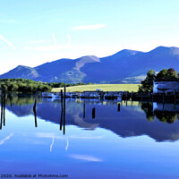 Buy canvas prints of Reflections in Derwentwater with Skiddaw mountain  by john hill