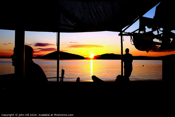 Sunset at beach bar on Tsougrias island in Greece. Picture Board by john hill
