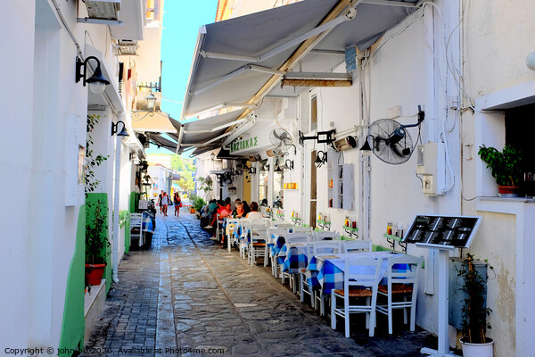 Food and drink in a back alley of Skiathos town in Greece.   e Picture Board by john hill