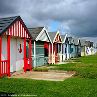 Buy canvas prints of Stormy skies over beach huts in Lincolnshire. by john hill