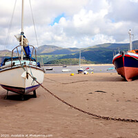 Buy canvas prints of Beached boats  and mountains at Barmouth in Wales. by john hill