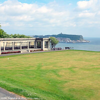 Buy canvas prints of Shelter and putting green with the town in the background at Scarborough in Yorkshire by john hill