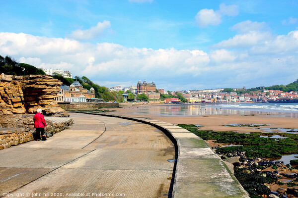 Walking the promenade towards Scarborough in Yorkshire. Picture Board by john hill
