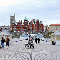 Buy canvas prints of The boardwalk and town from the pier at Cromer in Norfolk.  by john hill