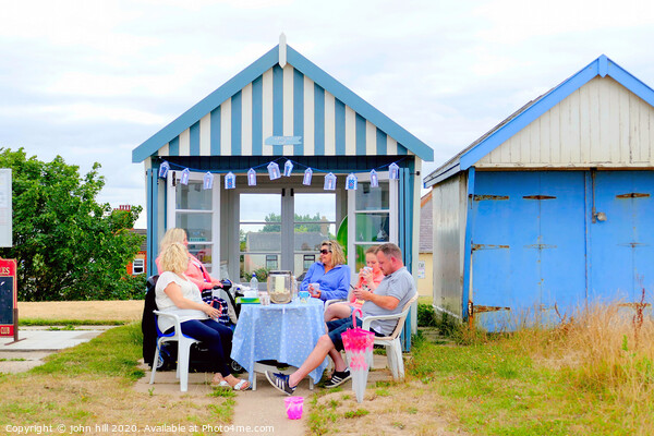 Beach hut tea party on the promenade at Sutton on Sea in Lincolnshire. Picture Board by john hill