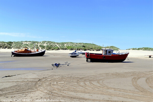 Beached boats on the beach at Barmouth in Wales. Picture Board by john hill