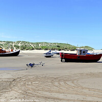 Buy canvas prints of Beached boats on the beach at Barmouth in Wales. by john hill
