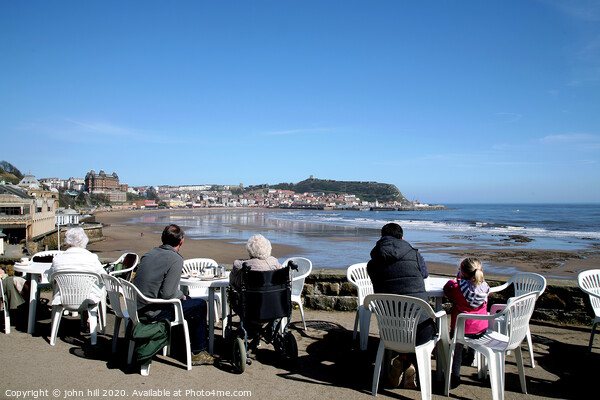 Tourists enjoying the view of Scarborough over the bay at low tide Picture Board by john hill
