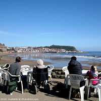 Buy canvas prints of Tourists enjoying the view of Scarborough over the bay at low tide by john hill