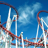 Buy canvas prints of Roller coaster loops against a blue sky at Ingoldmells in Skegness. by john hill