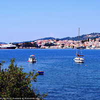 Buy canvas prints of Skiathos town from across the bay on Skiathos Island in Greece. by john hill
