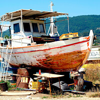 Buy canvas prints of Greek fishing boat having service in Dry dock. by john hill