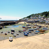 Buy canvas prints of Mousehole harbour at low tide in Cornwall. by john hill