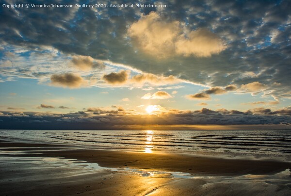 A sunset over a beach in Norfolk Picture Board by Veronica in the Fens