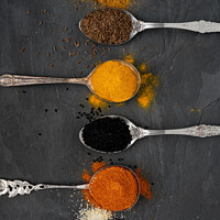 Buy canvas prints of Selection of spices on metal spoons by Thomas Klee