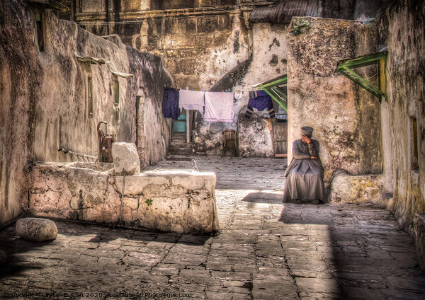 A backyard in Jerusalem old city with a resident sitting in deep contemplation.  Picture Board by Peter Bolton