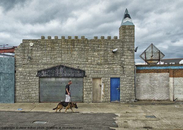 Man and dog walk in front of abandoned seaside arcade at Southend on Sea, Essex. Picture Board by Peter Bolton