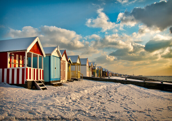 Beach huts at Thorpe Bay in winter with snow.  Picture Board by Peter Bolton