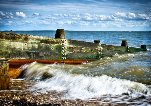 Waves crashing over a breakwater on the beach at Westcliff on Sea, Essex, UK Picture Board by Peter Bolton