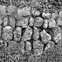 Buy canvas prints of Black and white photo art of a section of a dry stone wall at Lands End, Cornwall. by Peter Bolton