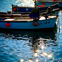 Buy canvas prints of Small boats at anchor in St. Ives harbour with sun light and shadows. Cornwall. by Peter Bolton