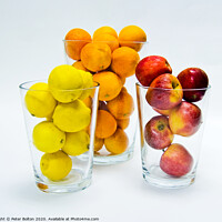 Buy canvas prints of Graphic design of lemons, apples and oranges arranged in glass tumblers. by Peter Bolton