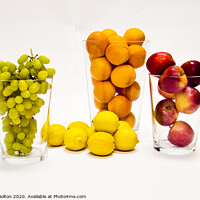 Buy canvas prints of Still life of fresh fruits arranged as graphic design on a white background by Peter Bolton