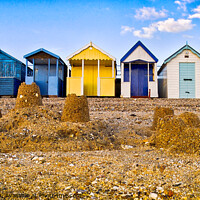 Buy canvas prints of Beach huts and sandcastles at Thorpe Bay, Thames Estuary, Essex, UK. by Peter Bolton
