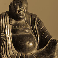Buy canvas prints of  Carved wooden buddha figure in sepia tones. by Peter Bolton