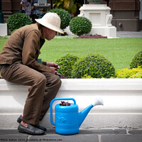 Buy canvas prints of A gardener at the Grand Palace, Bangkok, Thailand. by Peter Bolton
