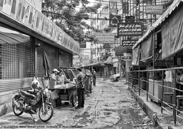 A side street in central Bangkok, Thailand, after heavy rain. Picture Board by Peter Bolton
