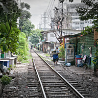 Buy canvas prints of Railway track in central Bangkok, Thailand, with houses alongside. by Peter Bolton