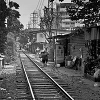 Buy canvas prints of Railway track in central Bangkok, Thailand, with houses alongside. by Peter Bolton