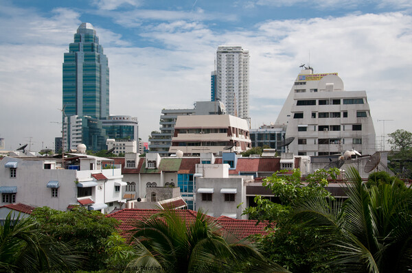 Cityscape of Bangkok, Thailand, showing dwellings and high rise buildings. Picture Board by Peter Bolton