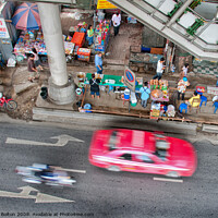 Buy canvas prints of Overhead view of a street with food vendors and traffic speeding past. Bangkok, Thailand. by Peter Bolton