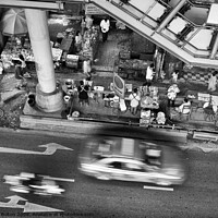 Buy canvas prints of Black and white view from overhead of a street with food vendors and traffic. Bangkok, Thailand. by Peter Bolton