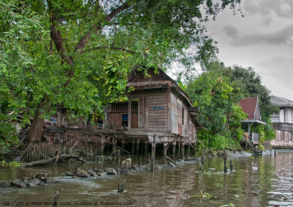 A typical dwelling on one of the canals off the Chao Phraya river, Bangkok. Picture Board by Peter Bolton
